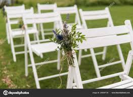 white wedding chairs decorated with