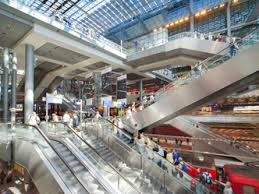 A set of stairs moved up or down by electric power on which people can stand and be taken from one level of a building to another, especially in shops, railway stations, and airports Tailored Escalators For Retail Centres From Kone Elevators Architecture Design