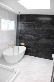 The marble is white with gray veining while the floor is black tile. 75 Beautiful Marble Tile Bathroom With Black Cabinets Pictures Ideas June 2021 Houzz
