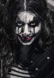 woman wearing evil clown makeup stock