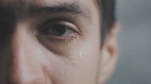 crying man with tears in eye