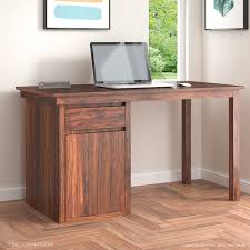 Crafted on a solid wood frame with your choice of a beautiful walnut or natural oak wood veneer top, this desk offers plenty of room to spread out while making the most of your living space. Flavia Sheesham Wood Computer Table With Storage Decornation