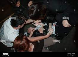 young man is tickled to the floor in nightclub dsc 5103 Stock Photo - Alamy