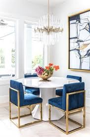 Description the modrest haslet modern white & rose gold dining chair features finely contoured lines upholstered in dainty white leatherette. A Round White Dining Table With Gold And Sapphire Dining Chairs Under A Brass And Lucite Chandeli Dining Room Inspiration Modern Dining Room White Dining Table