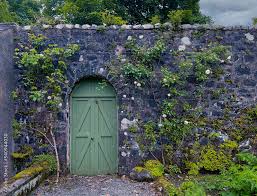 An Arched Green Gate Door On An English