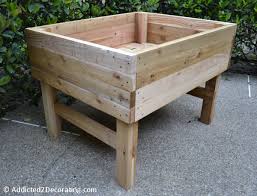 This wooden diy planter box is easy to build from cedar 1x4's. How To Build An Elevated Garden Addicted 2 Decorating