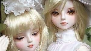 two cute barbie dolls in white dress