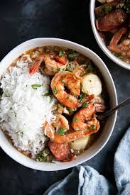 white bowl filled with prepared en sausage and seafood gumbo with white rice