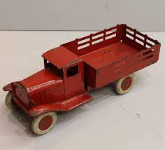 pressed metal stake bed red truck
