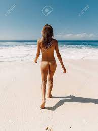 Attractive Naked Woman Posing At Tropical Ocean Beach. Slim Model With  Perfect Body Stock Photo, Picture and Royalty Free Image. Image 134068341.