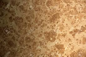 Brown Plain Stone Wall Background With A Faded Light Stock Photo