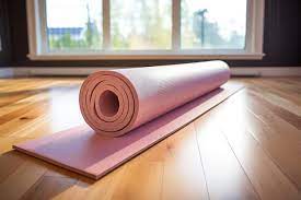 yoga mat rolled on a hardwood floor