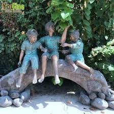 Bronze Statue Of Children On Log With