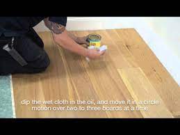 applying maintenace oil to wood floor