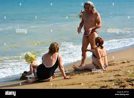 Grandmother and grandfather are playing with her granddaughter on the sea  beach. July 2017, Odessa, Ukraine Stock Photo - Alamy