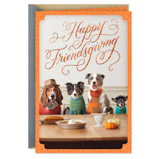 Thanksgiving greeting card celebrates friends who are like family and features a cute photograph of dogs dressed up and sitting at a dinner table with embossed foil lettering. Dining Dogs Friendsgiving Cute Thanksgiving Card Greeting Cards Hallmark