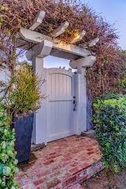 White Wooden Arched Gate With Pergola