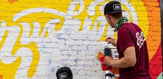 Painting A Mural On A Brick Wall