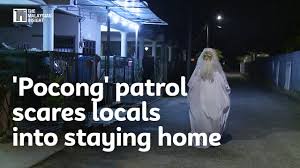 Pocong' patrol scares locals into staying home - YouTube