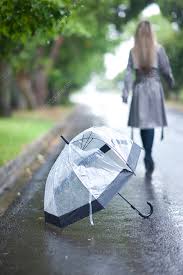 young woman and broken umbrella in park