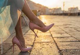 woman in high heel shoes in city by