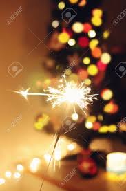 Christmas lights (also known as fairy lights, festive lights or string lights) are lights often used for decoration in celebration of christmas. Sparkle Stick With Lights And Christmas Tree On The Background Stock Photo Picture And Royalty Free Image Image 87009635