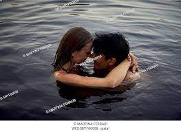 romantic couple embracing in lake at