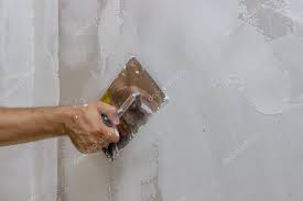 Trowel Plastering A Wall 3 Stock Photo