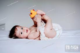 cute baby boy playing with duck toy