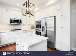 a bright kitchen with white cabinets