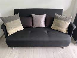 2 seater black sofa with cushions