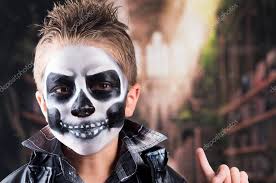 scary little boy wearing skull makeup