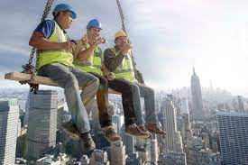 three construction workers sitting on