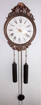 A Vintage Bronze Wall Clock Pendulum