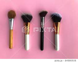 paintbrushes on a pink background