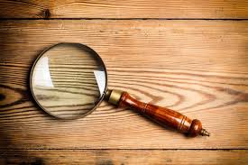 A Magnifying Glass On A Wooden Table In