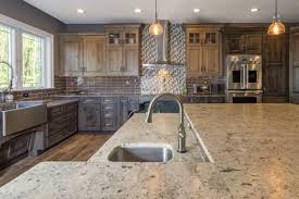 If a kitchen has only one sink, locate it adjacent to or across from the cooking surface and refrigerator. Counter Height Vs Bar Height The Pros Cons Of Kitchen Island Seating Styles Dura Supreme Cabinetry