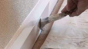painting baseboards with carpets
