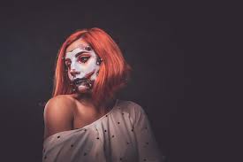 young woman with scary dead doll makeup