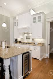 Not surprisingly, budgets play a significant role in the type of countertop a homeowner chooses too. Opulent White Kitchen With Granite Countertops And Wine Fridge Stock Photo Picture And Royalty Free Image Image 4255472