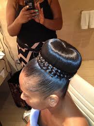 A bun is a type of hairstyle in which the hair is pulled back from the face, twisted or plaited, and wrapped in a circular coil around itself, typically on top or back of the head or just above the neck. The Best Black Updo Hairstyles