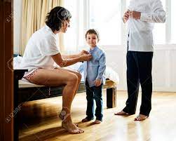 Mother Helping Son To Get Dressed Stock Photo, Picture and Royalty Free  Image. Image 90679911.