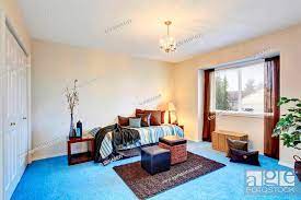modern bedroom with blue carpet floor