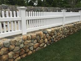 White Cape Cod Fence On A Garden Wall