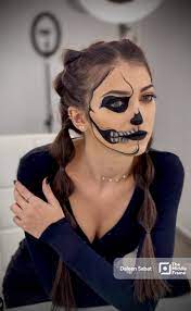 makeup artist showing half face the
