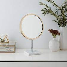 white marble base brass vanity mirror