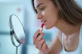 beautiful woman paints lips