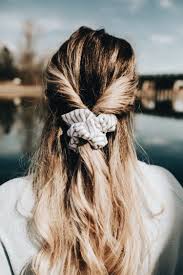 Looking ahead to the fall, scrunchies are still on the up and up. How To Wear A Scrunchie Half Up Half Down Hair Style With A Scrunchie Hair Styles Long Hair Styles Scrunchie Hairstyles