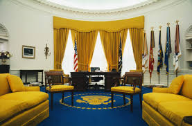 The desk is featured in the iconic photograph of a young john john kennedy poking is head through the secret door in front of the desk. Oval Office Decor Changes In The Last 50 Years Pictures Of The Oval From Every Presidency