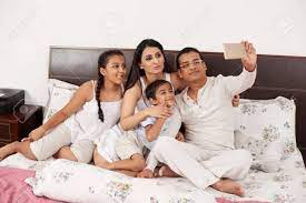 Happy Indian Family Taking Selfie Together In Bed Stock Photo, Picture And  Royalty Free Image. Image 77395795.